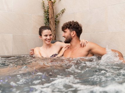 Explorer and wellness hotel near Sterzing Couple enjoying relaxing time in a hot tub