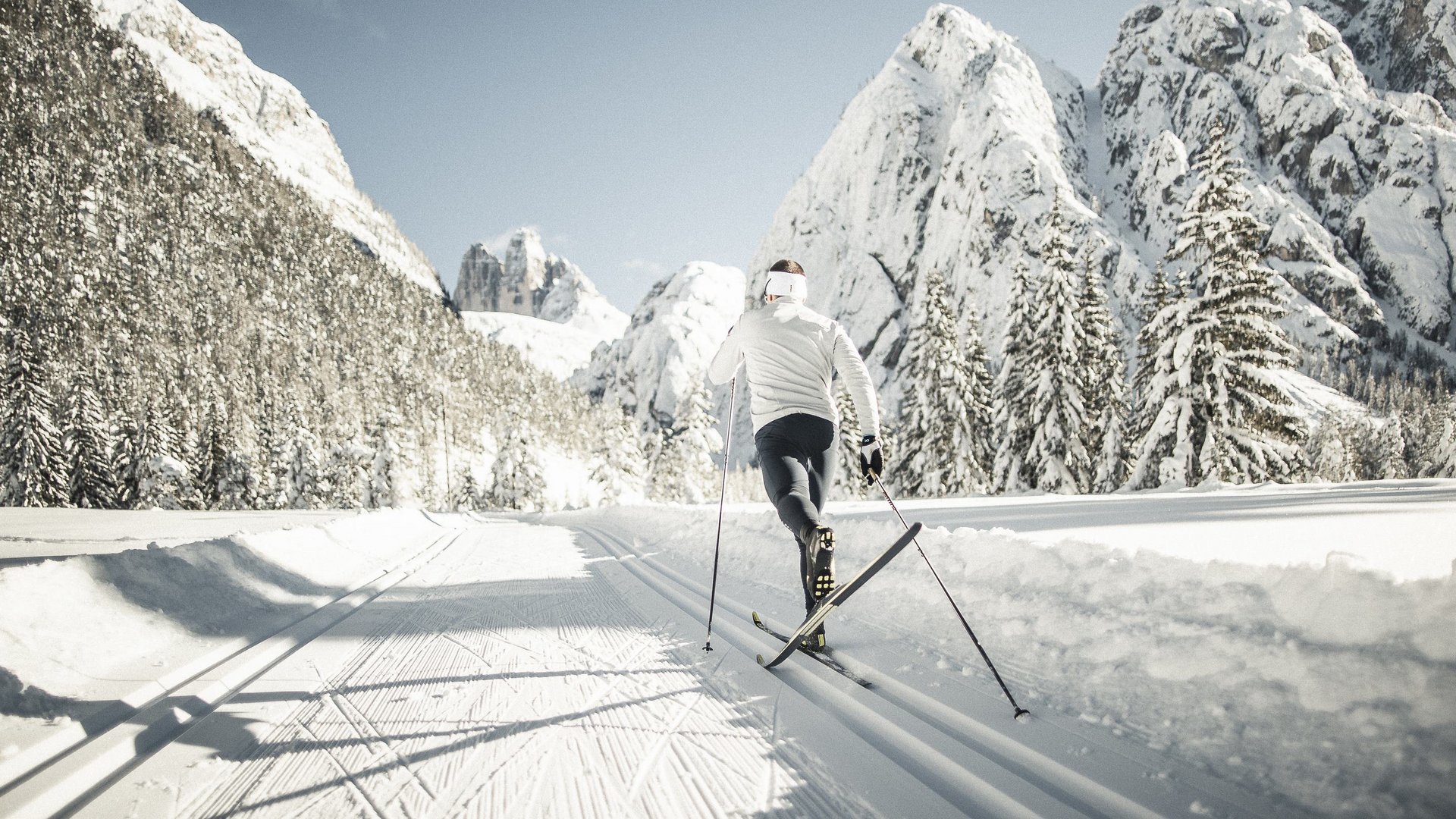 The Ladurns ski area and other winter highlights Cross-country skier on groomed trail in snowy mountain landscape