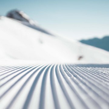 Gudruns Blog: alles über Sterzing, übers Wandern, über Tirol Gepflgte, mehrrillige Schneedecke vor verschneiten Bergen bei klarem Himmel