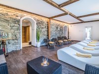 Gudrun in Gossensass: hotel with heart Cozy relaxation room with loungers and stone wall for unwinding