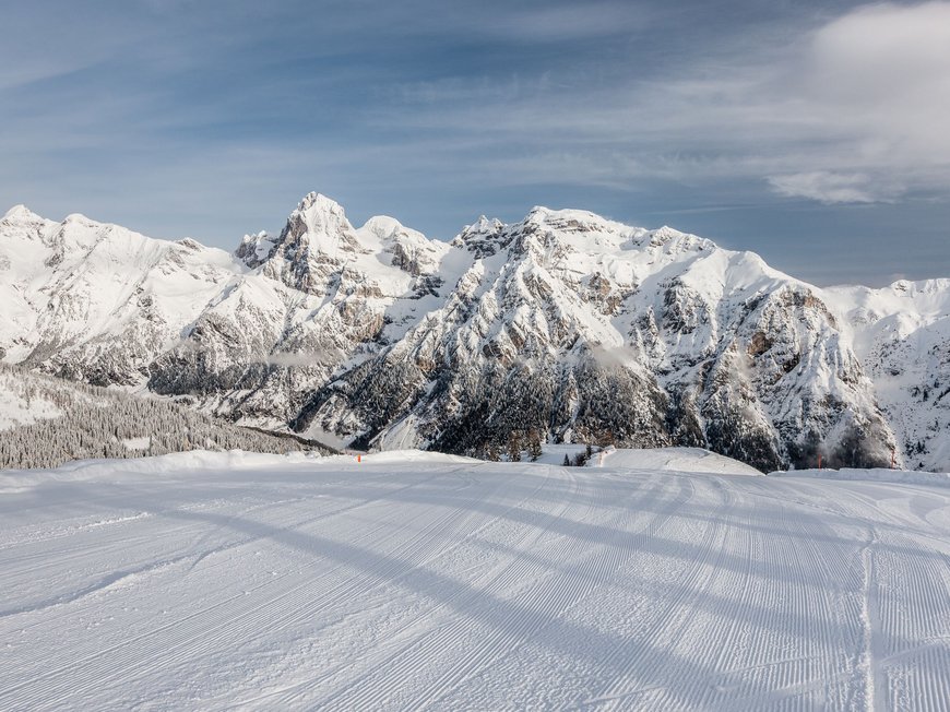 Hotel near Val di Fleres/Pflerschtal: location and arrival Freshly groomed ski slope with snowy mountains under blue sky