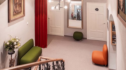 Dormire da Gudrun: hotel a Ladurns, a Colle Isarco Corridoio con poltrone verdi e arancioni, grande specchio e tenda rossa