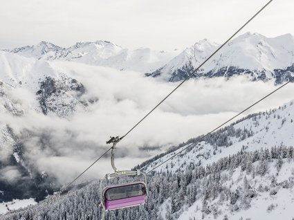 Gudrun in Gossensass: hotel with heart Chairlift over snowy mountains and forested slopes