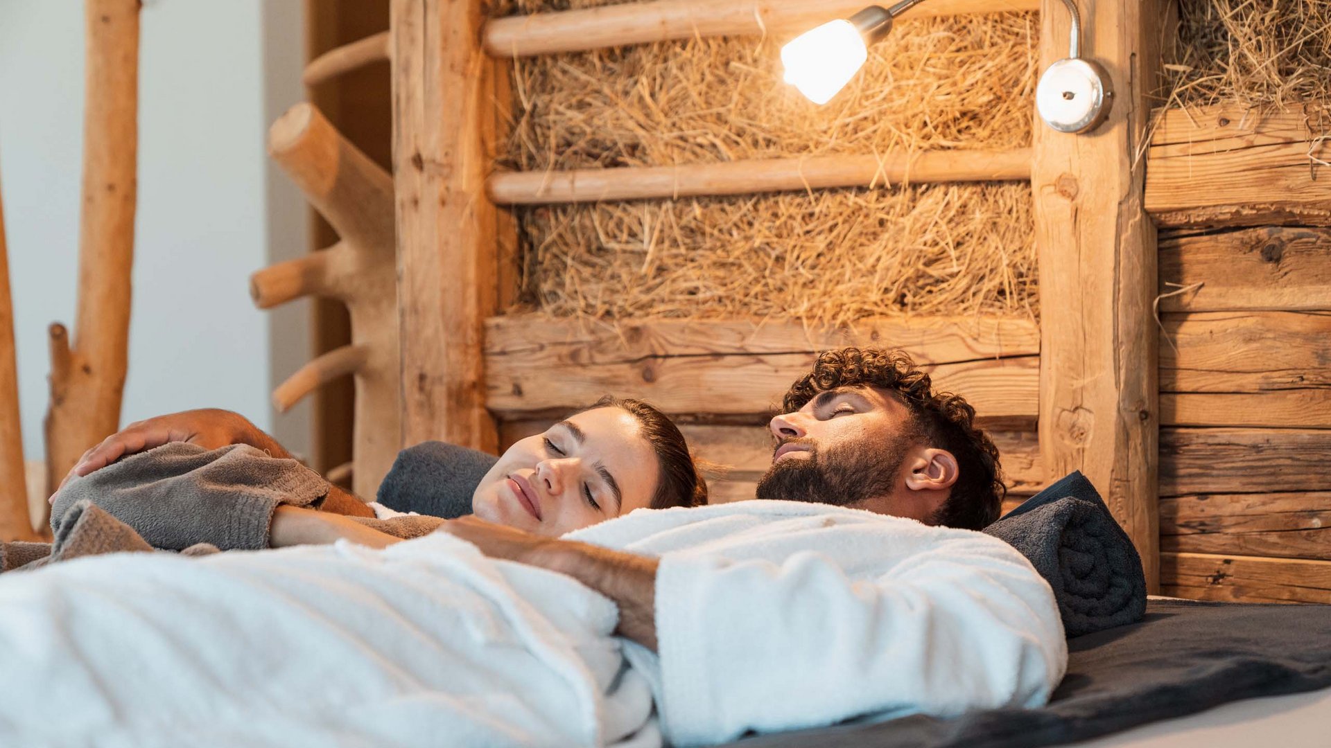 Explorer and wellness hotel near Sterzing Relaxed couple in robes resting in a rustic room